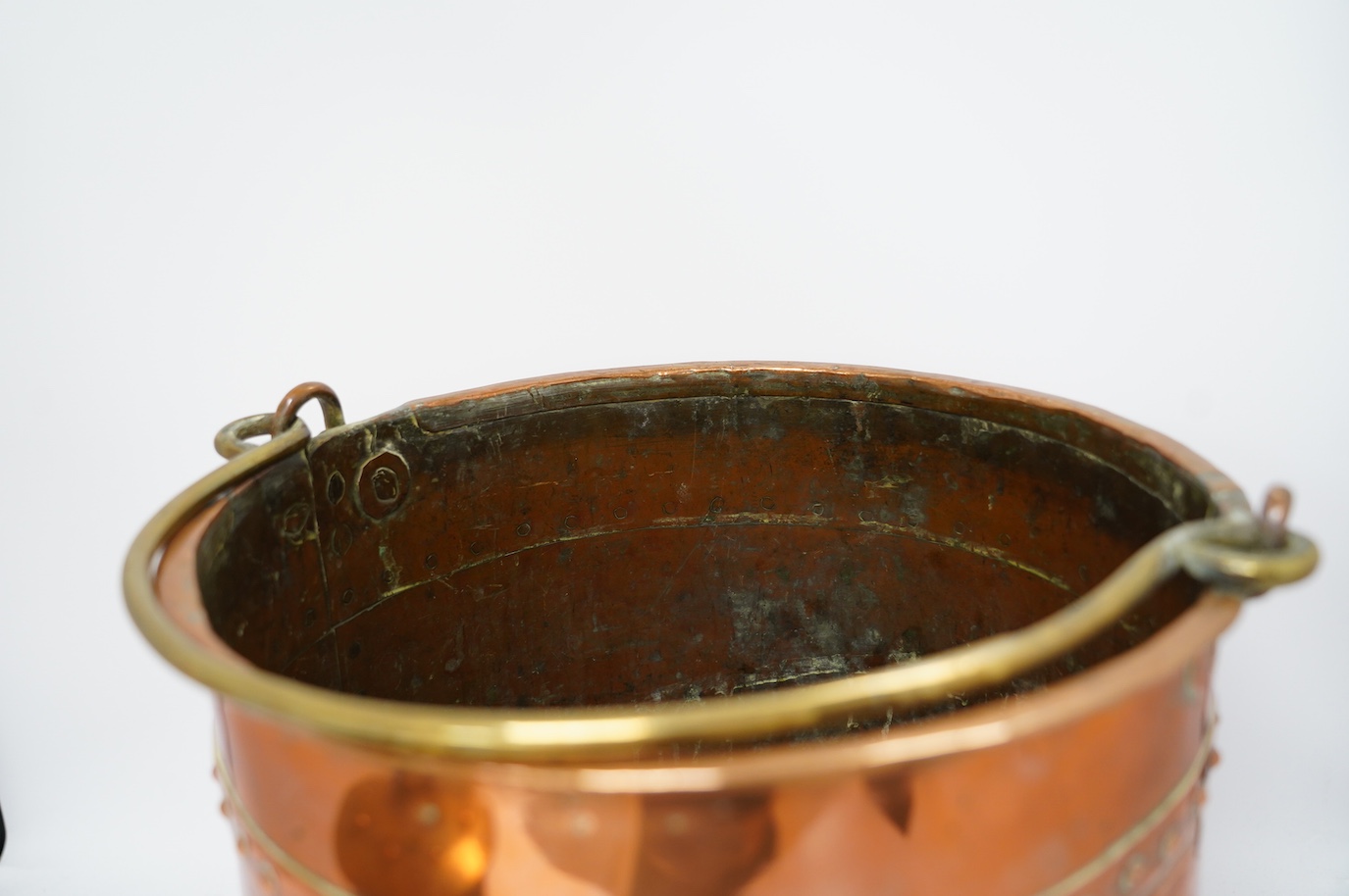 A brass handled copper coal bin and The Protector brass miner’s lamp, coal bin 30cm high. Condition - coal bin has some minor dents, miner’s lamp good